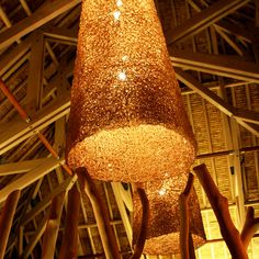 a large light fixture hanging from the ceiling in a room with wooden beams and ceilings