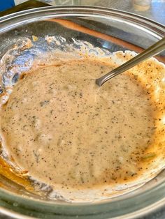 a bowl filled with sauce sitting on top of a table