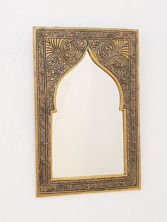 an ornate mirror hanging on the wall