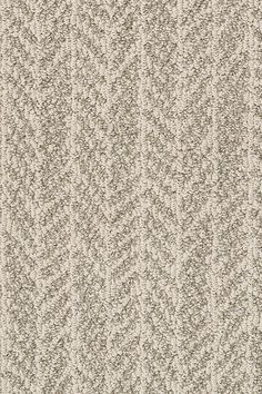 an up close view of a beige carpet with small, wavy lines on the side