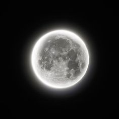 the full moon is seen in this black and white photo