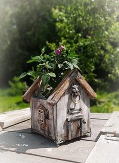 a small wooden house with a plant in it