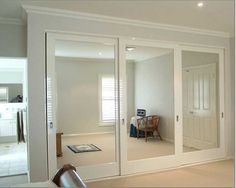 an empty room with white walls and sliding glass doors