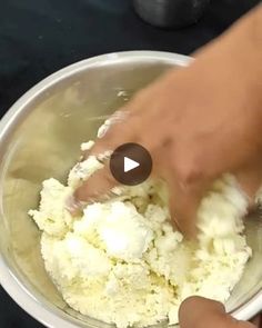 a person mixing food in a bowl on top of a table