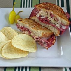 a sandwich and chips on a white plate