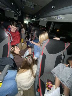 a group of people sitting in the back of a bus