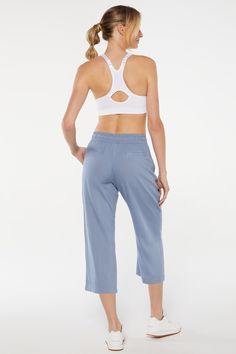 This spring, keep it cool, cute, and casual in this light three-piece set: a collared tank top with a button-up front, matching chambray pants with cropped pant legs, and a racerback bra with a zip-front closure. Spring Versatile Cropped Activewear, Summer Athleisure Activewear For Day Out, Sporty Summer Activewear For Day Out, Cropped Summer Bottoms For Daywear, Stretch Cropped Sporty Bottoms, Sporty Cropped Bottoms For Summer, Sporty Stretch Cropped Bottoms, Spring Activewear With Pockets For Loungewear, Chic Sleeveless Activewear For Spring