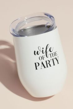 a white wine tumbler with the words wife of the party printed on it sitting on a pink surface