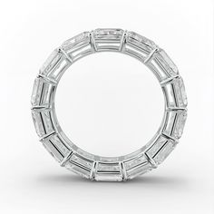 a white gold ring with baguetts set in the middle, on a white background