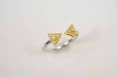 Not just another minimal ring, this ring combined modern and byzantine style in a way that makes it stand out from the others. A double triangle ring with genuine diamonds, made of sterling silver 925 and 18k solid gold. This geometric open ring it's a minimal piece of jewelry that you can wear it alone for a minimal look or stack it and create a unique look ! A perfect Christmas gift ring, an unforgettable proposal ring or just a gift to yourself ! Items Details: - Materials: 18K Gold, Sterling Modern Adjustable Rings With Single Cut Diamonds, Engagement Ring Minimalist, Double Triangle, Two Tone Ring, Triangle Ring, Minimal Ring, Everyday Ring, Simple Ring, Geometric Ring