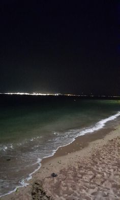 an empty beach at night with no people on it