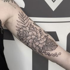 a woman with a flower tattoo on her arm