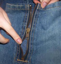 a person is holding their pocket open to show the inside of his jeans that are zipperped