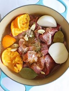 a pot filled with meat and vegetables on top of a table