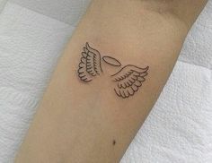 a tattoo with two wings on the arm