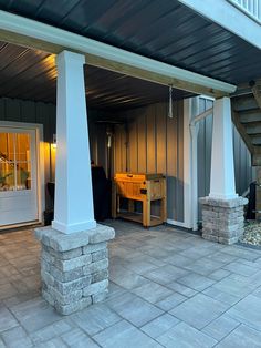 an outside patio area with stairs leading up to the front door