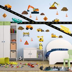 a child's bedroom with construction themed wall decals and toys on the floor