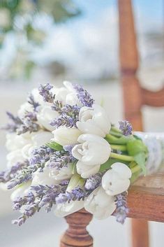 a bouquet of flowers sitting on top of a wooden chair