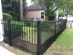 a black metal fence in front of a house