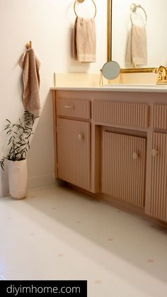 a bathroom with a sink, mirror and towel rack