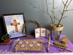 the table is set up with an assortment of items including a cross, candles and cards