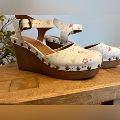 Nwot Lucky Brand Wedges With Cute Clog And Floral Design. I Don’t See A Size On The Shoe, But I Am A Size 8 And They Fit Nice. Spring Wedge Heel Clogs Medium Width, Spring Medium Width Wedge Heel Clogs, Spring Casual Wedge Heel Clogs, Casual Wedge Heel Clogs For Spring, Casual White Wedge Heel Clogs, Spring Clogs With Stacked Wedge Heel, White Wedge Sandals With Wooden Heel, Casual Wedge Heels With Floral Print, Casual Floral Print Wedge Heels