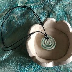 ŽeljArt ceramic handmade necklace in turquoise color with a spiral motif. Each of my necklaces is unique and different and encourages my customers to choose and browse what suits them. It is tied on a strong black string that moves and adjusts to the length that suits you, such as all the way to the neck or a longer length. Spiritual Handmade Round Pendant Necklace, Spiritual Single Strand Round Necklace, Adjustable Spiritual Necklace With Round Pendant, Spiritual Hand-strung Round Beaded Necklaces, Hand-strung Spiritual Turquoise Necklace With Round Beads, Round Pendant Necklace, Ceramic Handmade, Round Necklace, Round Pendant