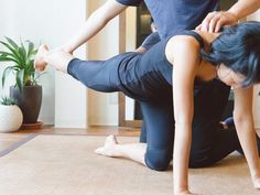 two people are doing yoga on the floor