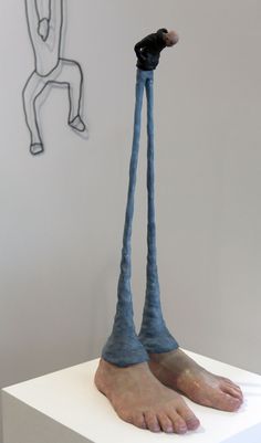 a sculpture of a person with long legs