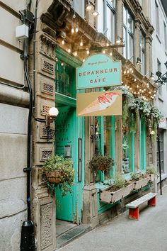 an old building with a sign that says beauanneur cafe on the front door