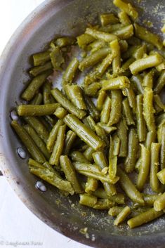 some green beans are in a pan on the stove top, ready to be cooked