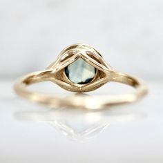 a yellow gold ring with a blue topazte stone in it's center