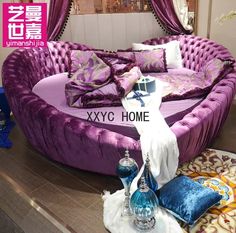 a purple couch with pillows on top of it