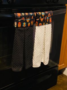 three pairs of socks hanging from the oven rack