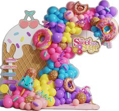 an ice cream cone filled with lots of donuts and other colorful balloons that spell out the number one