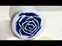 a white and blue rose shaped object sitting on top of a counter