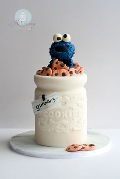 the cookie monster is sitting on top of some cookies