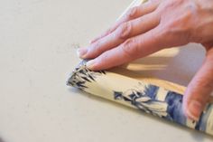 a person is using a cloth to clean the counter top with a rag on it