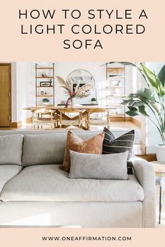 a living room with white couches and pillows on top of it, text overlay reads how to style a light colored sofa