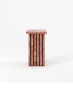 a small wooden table sitting on top of a white floor