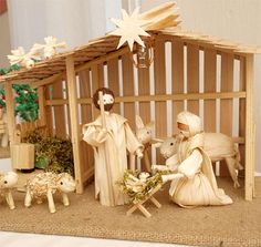 a nativity scene with figurines and sheep