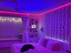 a bed room with a neatly made bed and purple lighting