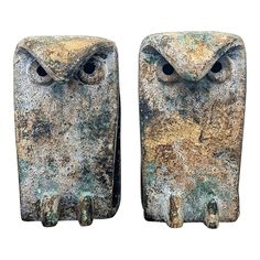 two old metal owls sitting next to each other