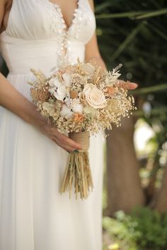 a woman holding a bouquet of flowers in her hands