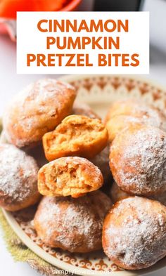 cinnamon pumpkin pretzel bites on a plate with powdered sugar in the middle