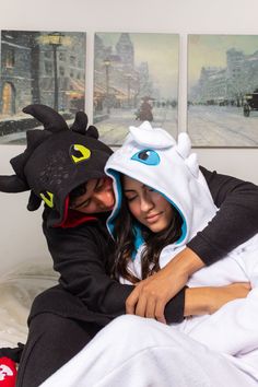 a man and woman dressed in costumes hugging on a bed