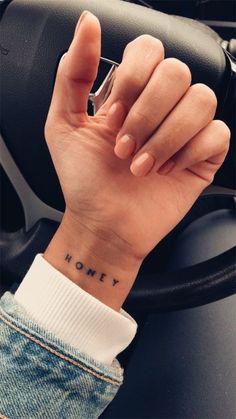 a person with a small tattoo on their wrist