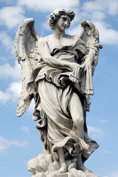 an angel statue is shown against a blue sky