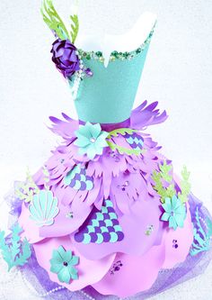 a dress made out of paper with flowers on the bottom and purple, blue, green and white colors