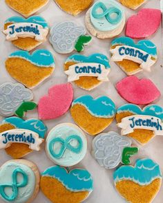 decorated cookies in the shape of hearts with words and symbols on them are displayed for display